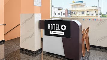 A hotel reception desk with a sign indicating it is serviced by YOYO.