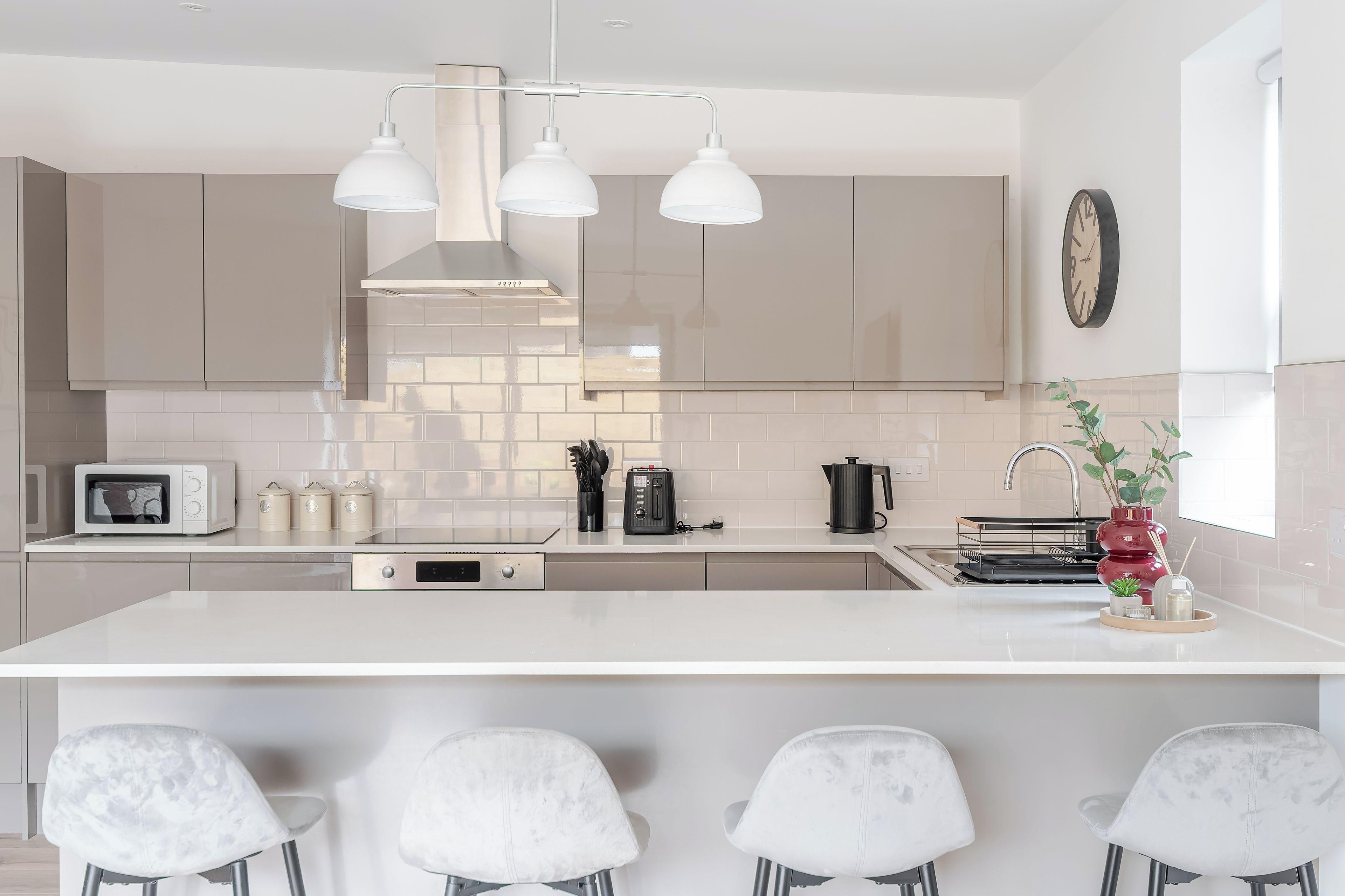 A modern kitchen with a central island, stainless steel appliances, and a minimalist design.