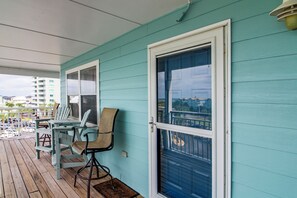 A wooden deck with outdoor seating and a view of a residential area. - Unwind Poolside, Walk to Beach! Pensacola Getaway (Pensacola Beach)