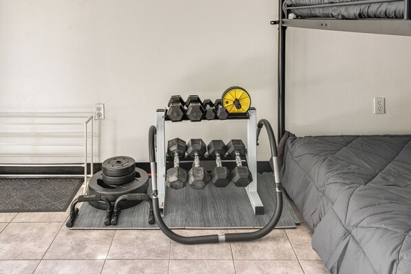 A home gym setup with a weight bench, a rack of dumbbells, and a barbell. - 6 Mi to Spanish Springs! Private Unit w/ Projector (Lady Lake)