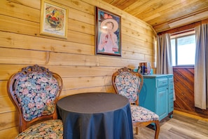 A wooden interior with two ornate chairs, a round table, and a blue cabinet. - 6-acre Barndominium Escape, 6 Mi to Lake Cleburne! (Cleburne)