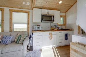 A compact kitchen with a microwave, toaster, and wooden cabinets. - Steinhatchee Escape! Perfect For Anglers + Hunters (Steinhatchee)