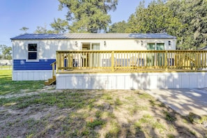 A single-story house with a covered porch, a small deck, and a fenced yard. - Steinhatchee Escape! Perfect For Anglers + Hunters (Steinhatchee)