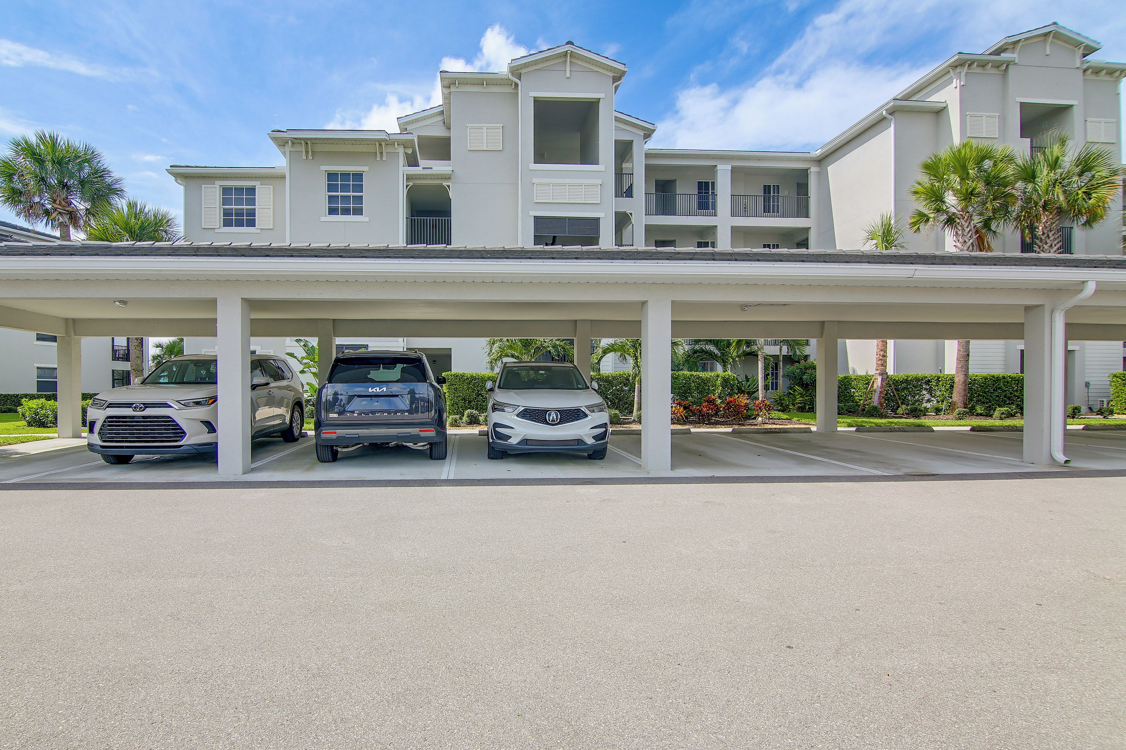 A multi-story building with a covered parking area.
