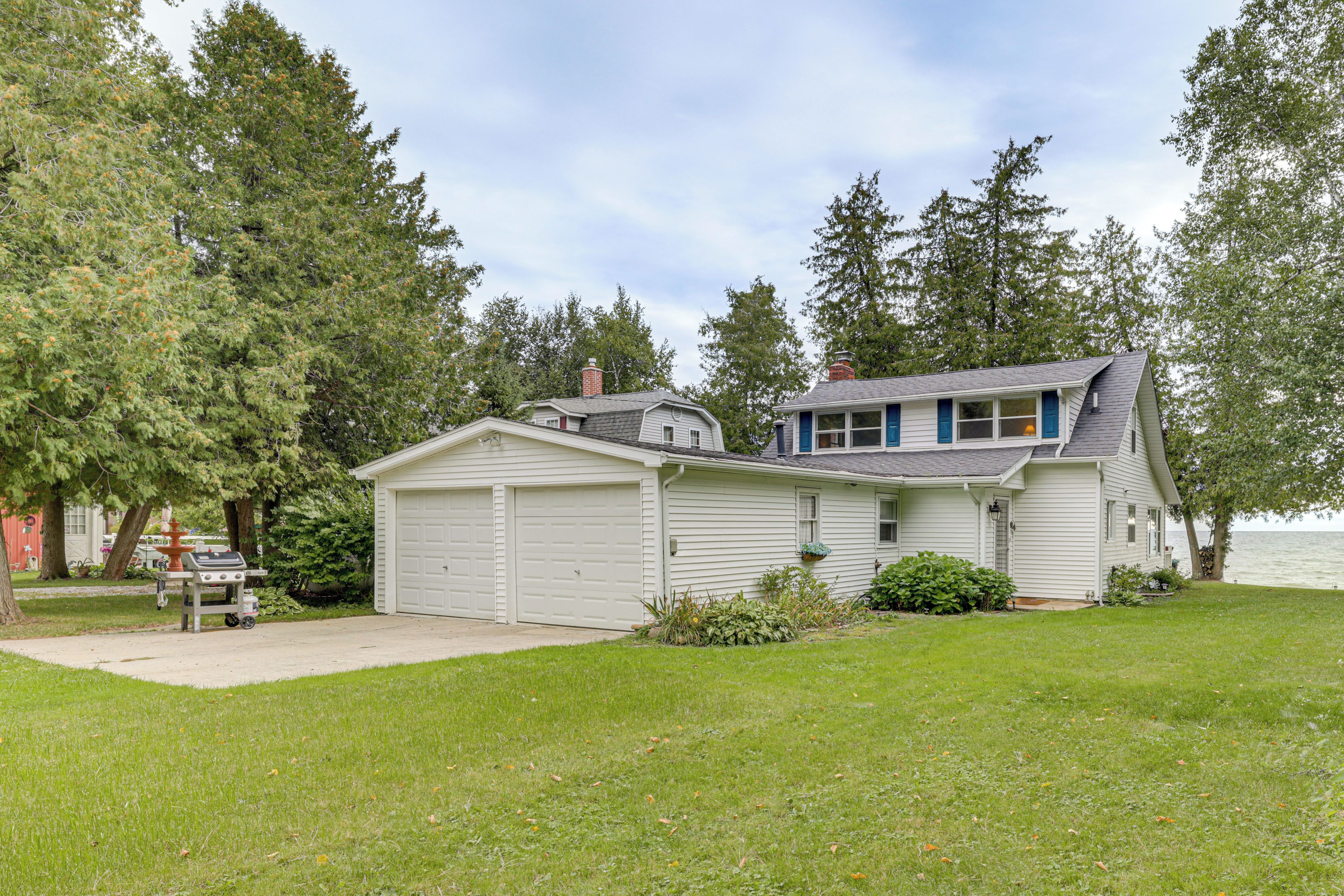 A single-story house with a garage, a small porch, and a lawn.