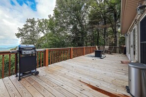 A wooden deck with a barbecue grill, outdoor furniture, and a view of trees and mountains. - Hot Tub & Mtn Views: Wolf Laurel Home (Mars Hill)