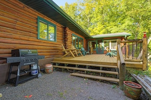 A log cabin with a deck, outdoor grill, and seating area. - North Woods Log House w/ Exceptional Privacy! (Stone Lake)