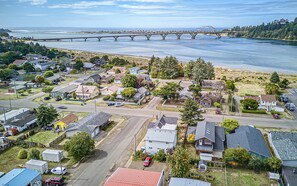 A residential area with houses, a bridge, and a body of water. - Holiday at Alsea Bay: 1 Block to the Bay! (Waldport)