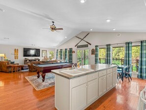A spacious living area with a pool table, a television, and a ceiling fan. - 2 houses sit on 1350ft Peninsula-Sleeps 18-Waterslide. Green light. Fish Feeder. (Dadeville)