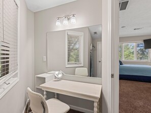 A bathroom with a vanity, mirror, and a window with blinds. - 2 houses sit on 1350ft Peninsula-Sleeps 18-Waterslide. Green light. Fish Feeder. (Dadeville)