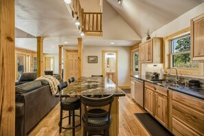 A spacious kitchen with a central island, wooden cabinets, and a view of the outdoors. - Fall Escape Special: 15% Discount Ends Nov 30! Must book by Oct 18 (Pagosa Springs)