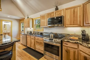 A modern kitchen with wooden cabinets, stainless steel appliances, and a marble countertop. - Fall Escape Special: 15% Discount Ends Nov 30! Must book by Oct 18 (Pagosa Springs)