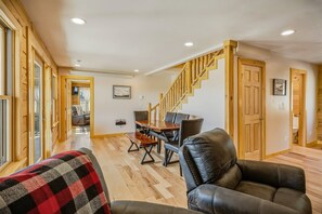 A spacious living area with a wooden staircase, a dining table with chairs, and a leather sofa. - Fall Escape Special: 15% Discount Ends Nov 30! Must book by Oct 18 (Pagosa Springs)