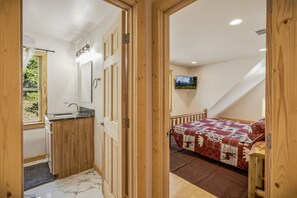 A compact bedroom with a bed, a television, and a view of the outdoors. - Fall Escape Special: 15% Discount Ends Nov 30! Must book by Oct 18 (Pagosa Springs)