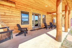 A wooden cabin with a covered porch, outdoor seating, and a view of the landscape. - Fall Escape Special: 15% Discount Ends Nov 30! Must book by Oct 18 (Pagosa Springs)