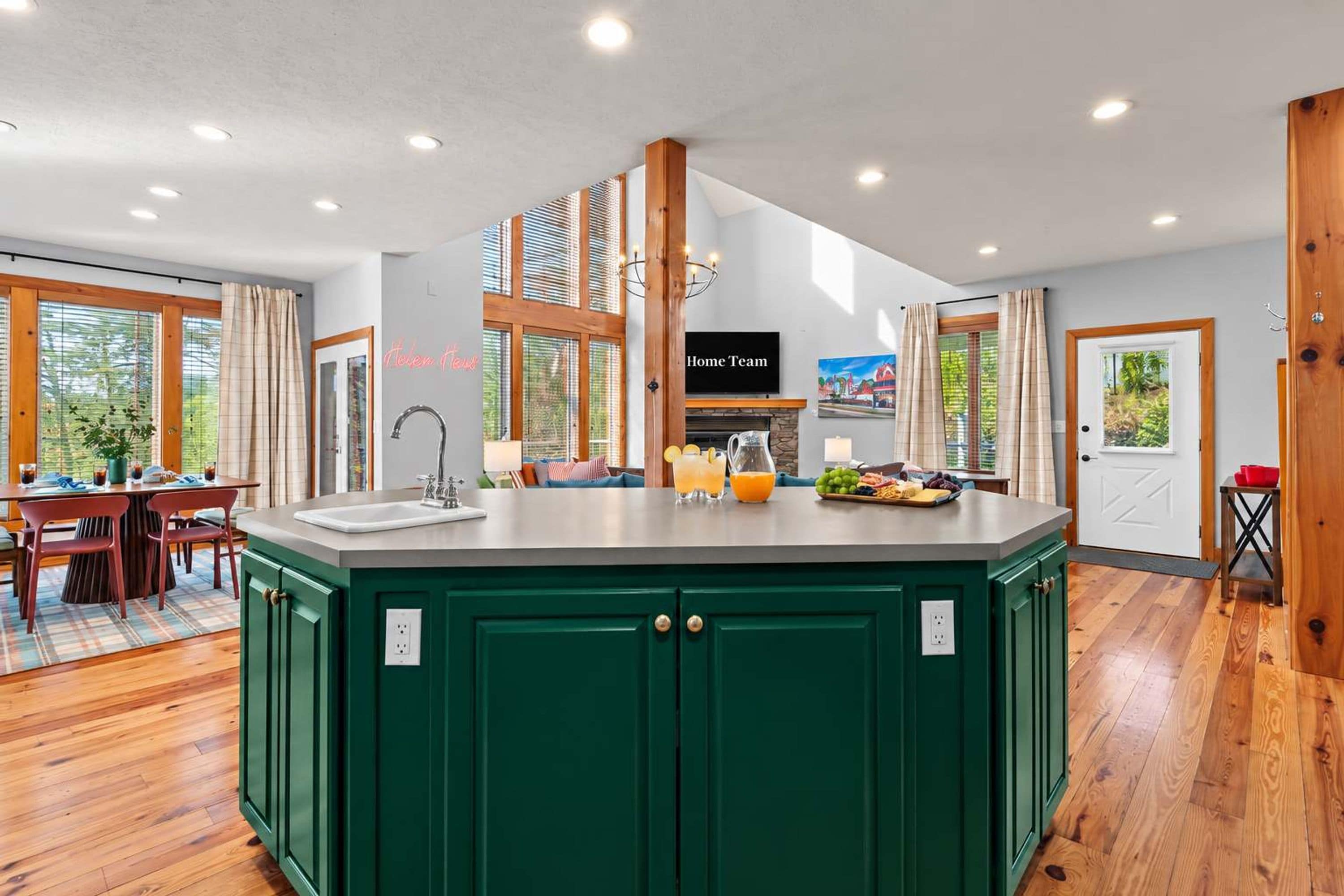 A spacious kitchen with a central island, wooden cabinets, and a dining area with a table and chairs.