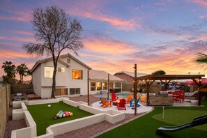 Ein Wohngrundstück mit Swimmingpool, Sitzgelegenheiten im Freien und Grillplatz.