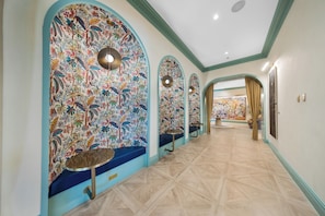 A hallway with arched ceilings, patterned walls, and a tiled floor. - Cozy 1BR- Pool -Steps to Wynwood Walls (Miami)