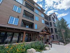 A multi-story building with balconies, a wooden facade, and a sign reading 'The Dakota 150'. - Pool View| Walk to Slopes, Dining, Shops (Keystone)