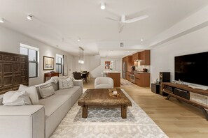 A modern living room with a sofa, coffee table, and a TV. - Luxurious beautifully renovated Coconut Grove retreat with private Hot tub. (Miami)
