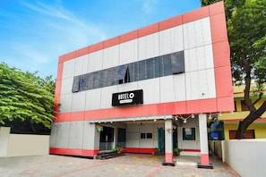 A two-story building with a sign reading 'HOTEL' and 'Company Serviced.' - Hotel O Kanyakumari Near Sunrise View (Nagercoil)