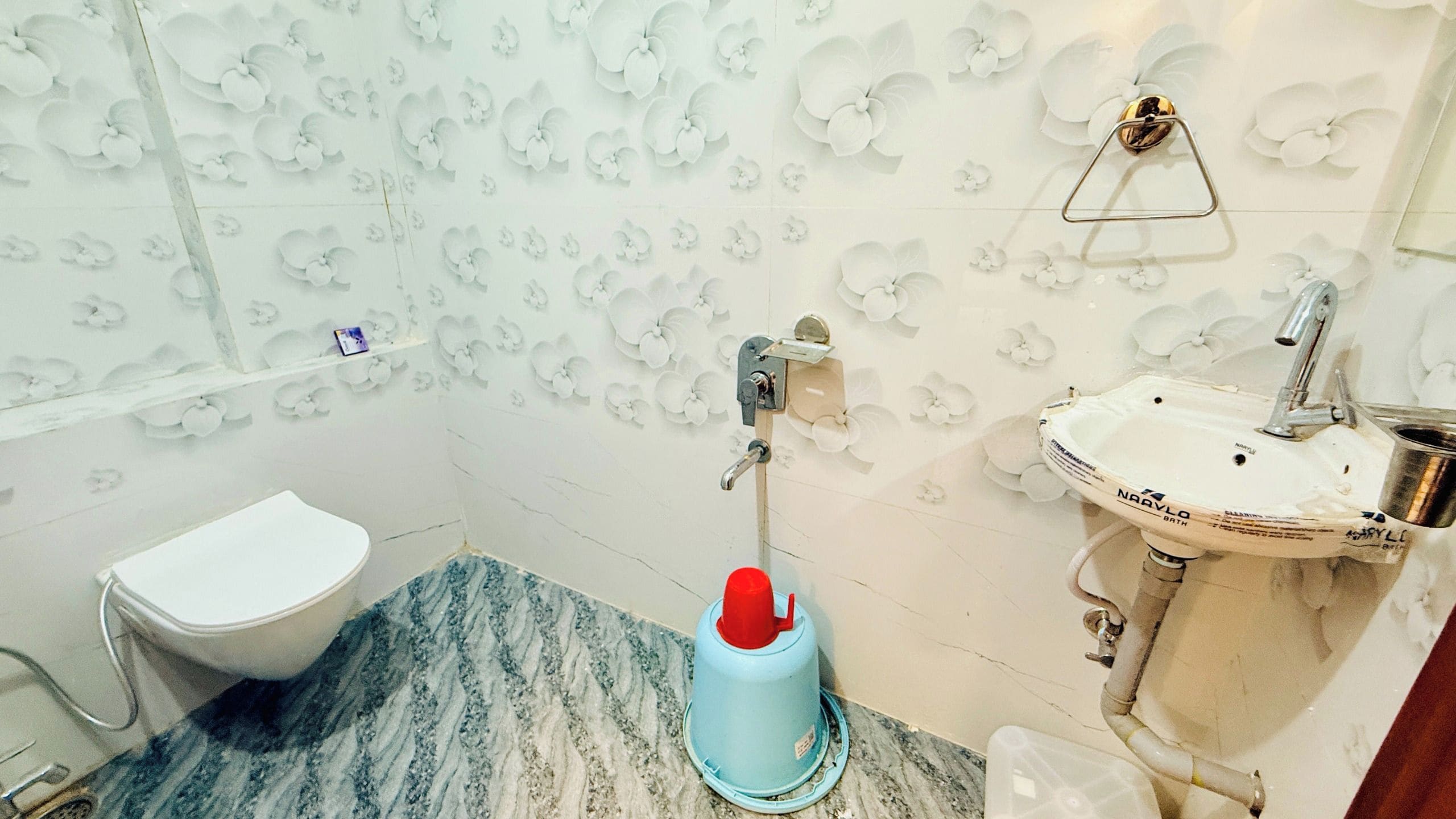 Un baño con inodoro, lavamanos y zona de ducha.