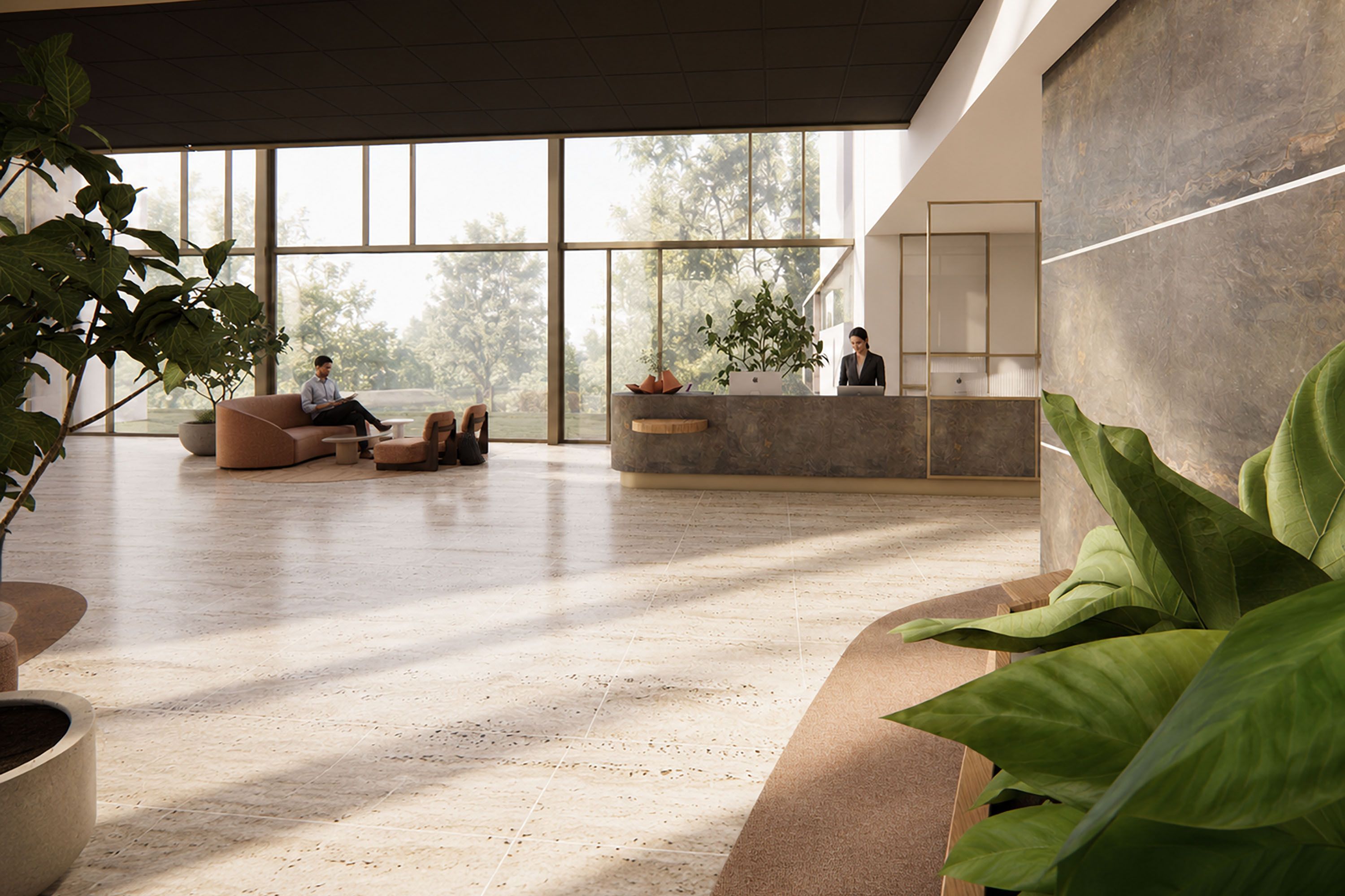 A spacious lobby with a reception desk, seating area, and large windows.