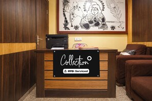 A reception desk with a sign reading 'Collection' and 'OYO-Serviced'.