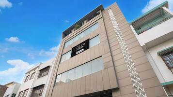 A modern building with a sign indicating 'Collection' and 'OYO-Serviced' services.