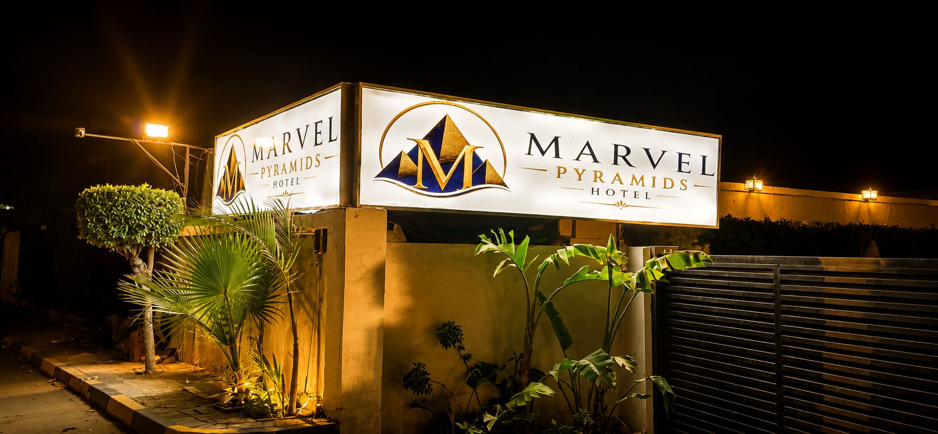 A hotel sign with the name 'Marvel Pyramids Hotel' and a logo.