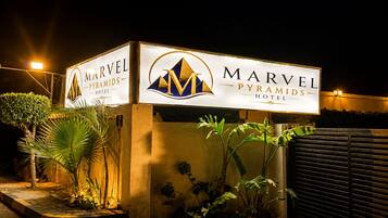 A hotel sign with the name 'Marvel Pyramids Hotel' and a logo.