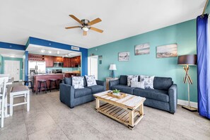 A modern living room with two sofas, a coffee table, and a ceiling fan. - 🌴Laketown Wharf 907 | Gulf Views | Balcony | Pools🏊‍♀️ (Panama City Beach)