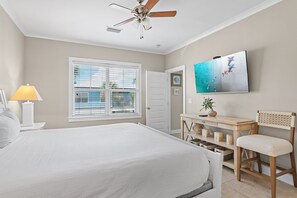 A bedroom with a bed, a ceiling fan, a window with blinds, a TV on the wall, and a desk with a chair. - ☀️White Sands Escape | Coastal Retreat | 700 Yards to Beach | Pool☀️ (Miramar Beach)