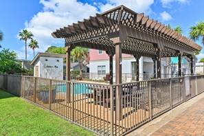 A covered outdoor area with a pool, surrounded by a fence, and adjacent to a building with a sign reading 'Leisure Bay'. - ☀️White Sands Escape | Coastal Retreat | 700 Yards to Beach | Pool☀️ (Miramar Beach)