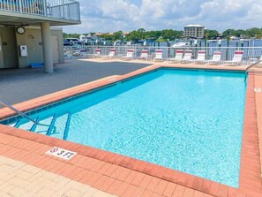 A rectangular swimming pool with a 3 FT depth marker, surrounded by a brick deck and metal railings. - 🎣 Palm Court Yacht Club 604 | Waterfront Views, Pool & Fishing Dock 🌊 (Fort Walton Beach)