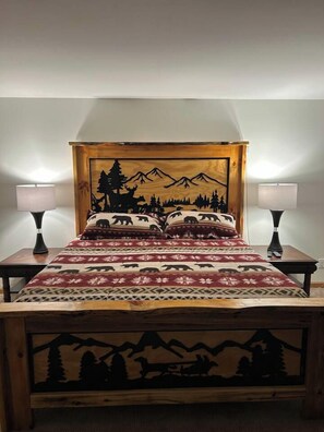 Cozy up with bear-themed linens on this comfortable king bed.