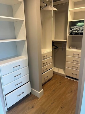 A walk-in closet with open shelving, drawers, and hanging space. - Waterfront Lake Charlevoix|Private Dock, Fire Pit (Boyne City)