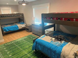 A room with bunk beds, a desk, a chair, and a window. - Waterfront Lake Charlevoix|Private Dock, Fire Pit (Boyne City)