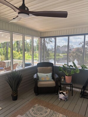 A covered porch with a ceiling fan, a chair with a cushion, a potted plant, and a view of the outdoors. - Life on the Lake, Come on down to South GA, only three miles to the Fl. line (Lake Park)