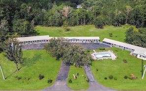 A large building with multiple rooms, a central courtyard, and a swimming pool.