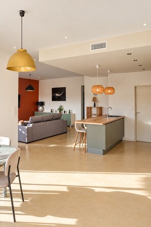 A modern interior with a kitchen island, dining area, and living space.