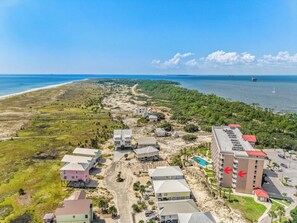 A coastal hotel with multiple buildings, a swimming pool, and a view of the ocean. - The Dunes 🏖️ Walk to Beach with Indoor + Outdoor Pools + Hot Tub (Fort Morgan)