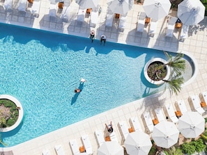 Dive into sparkling blue waters and sun-drenched loungers. - Your Private Arc Hideaway with Terrace, Beach Access & South Bank Resort Perks (Long Bay Hills)