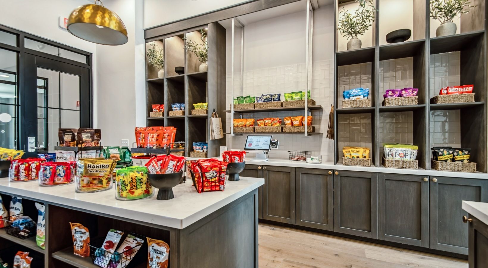 A snack bar with various packaged snacks and a self-serve coffee station.
