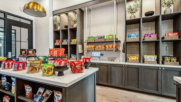 A snack bar with various packaged snacks and a self-serve coffee station.