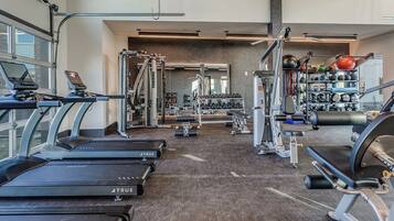 A gym with treadmills, weight machines, and free weights.