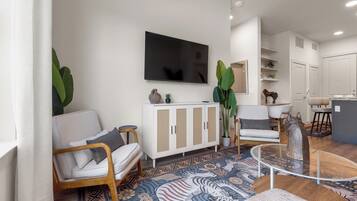 A modern living room with a sofa, a TV, a cabinet, and a coffee table.