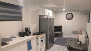 A compact kitchenette with a refrigerator, microwave, toaster, and coffee maker. - New Modern 1BR Suite With Private Entrance - Easy Access To Malls (Winnipeg)