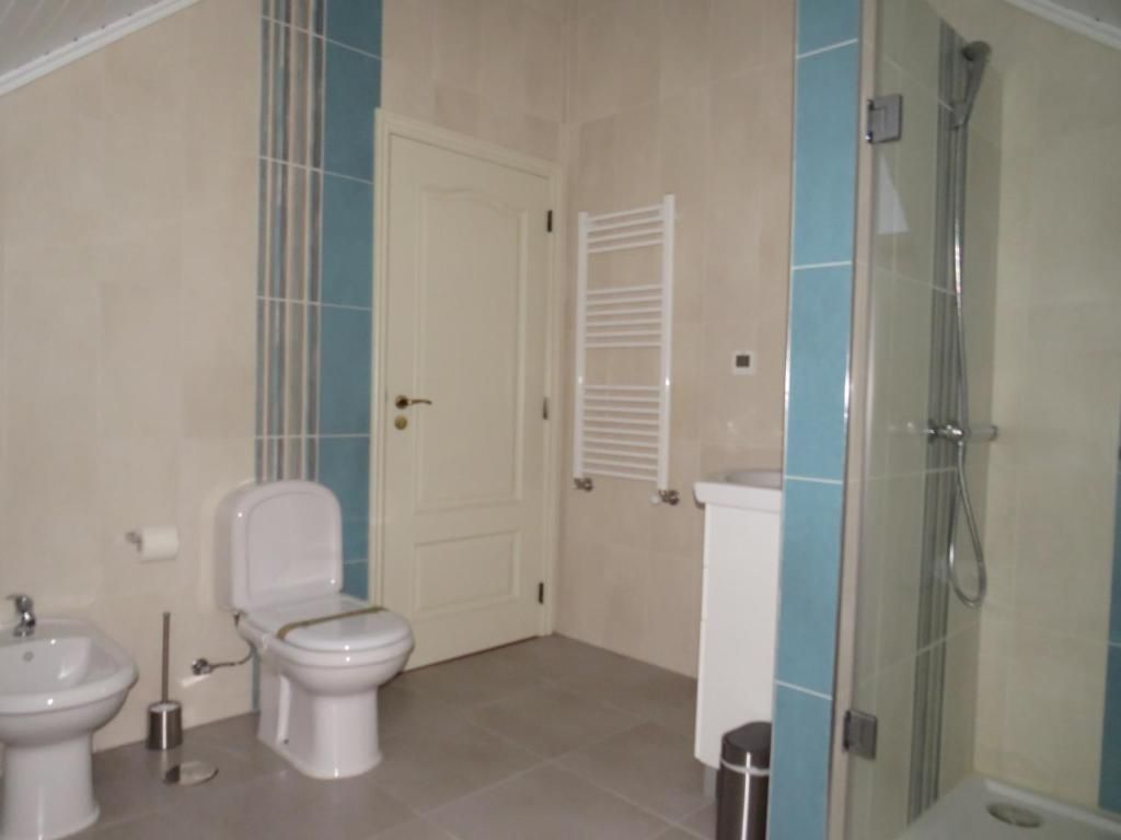 Un baño con inodoro, bidé y ducha.