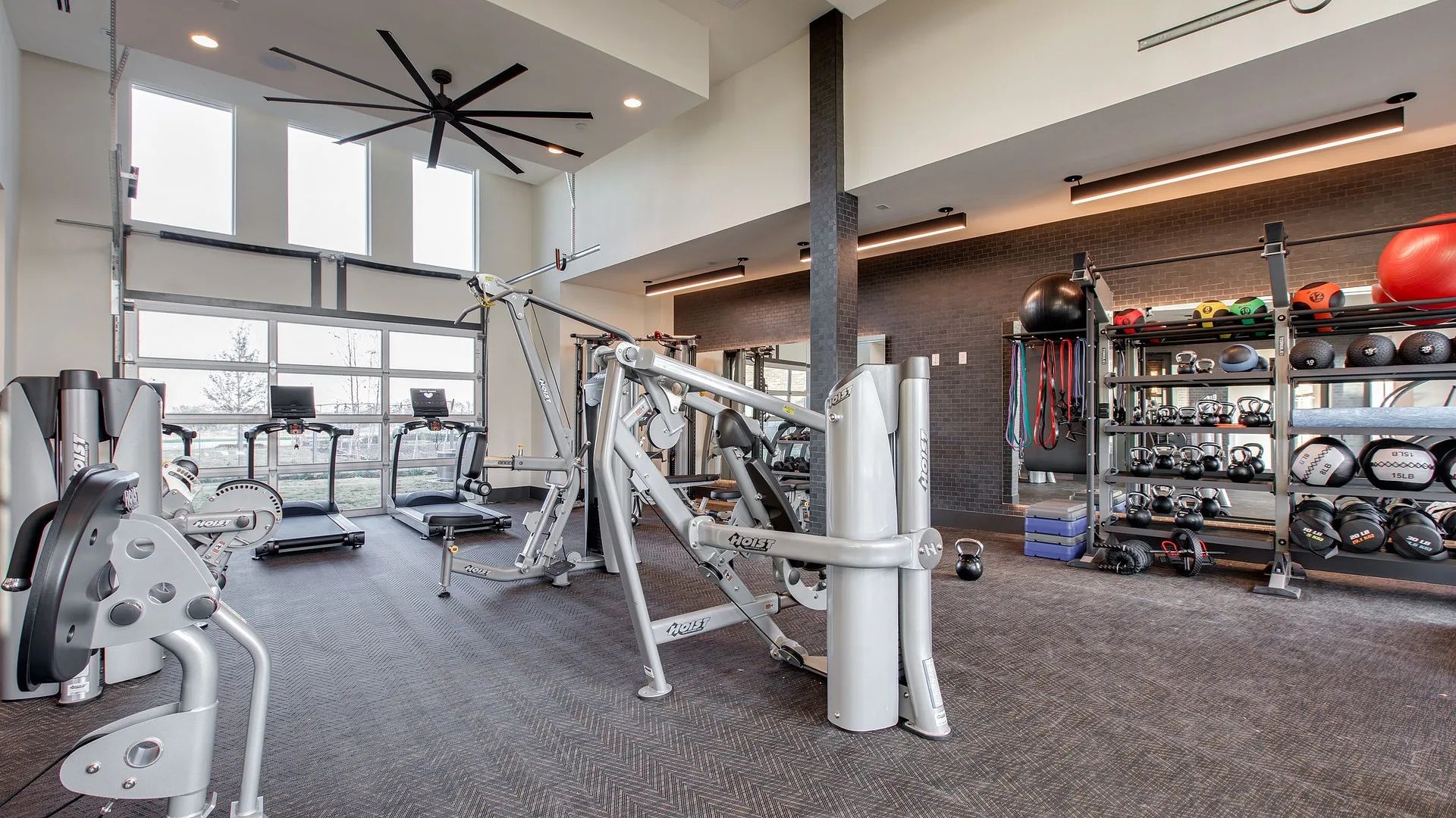 A gym with various exercise equipment, treadmills, and weightlifting stations.